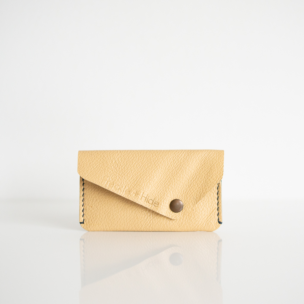 Card wallet made from upcycled sofa leather in yellow with blue stitiching